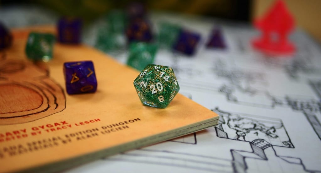 A Dungeons and Dragons table wit various books, notebooks, dice and plastic figures